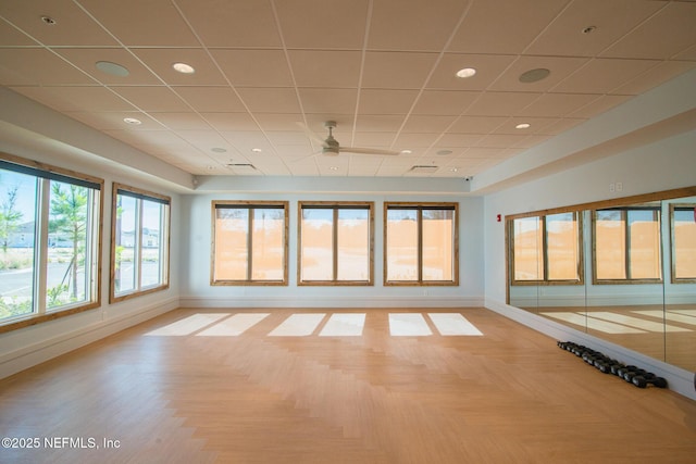 spare room with a drop ceiling, recessed lighting, a ceiling fan, and baseboards