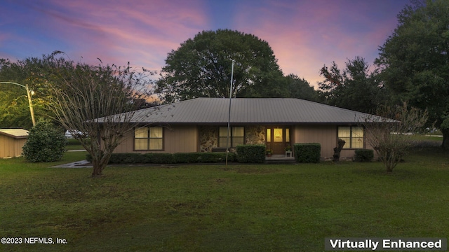 view of front of home with a front lawn and metal roof