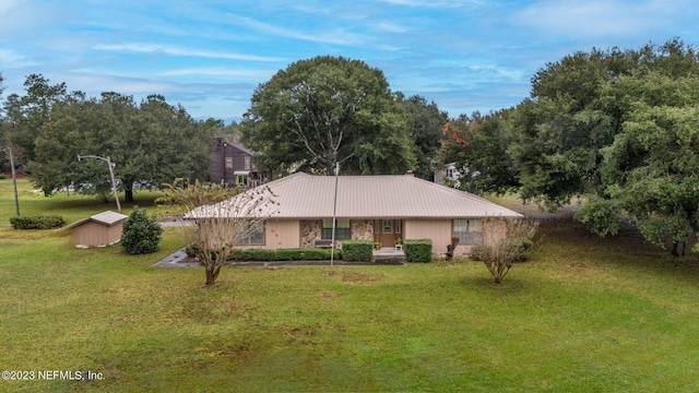 single story home featuring a front lawn and metal roof