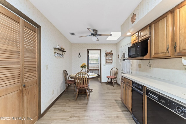 kitchen featuring visible vents, black appliances, wallpapered walls, and light countertops