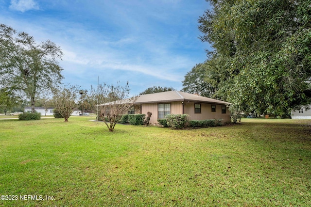 view of property exterior with a lawn