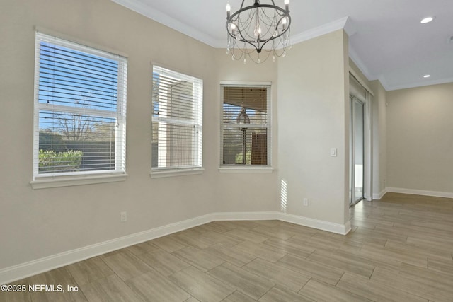 unfurnished room with crown molding, baseboards, and a chandelier