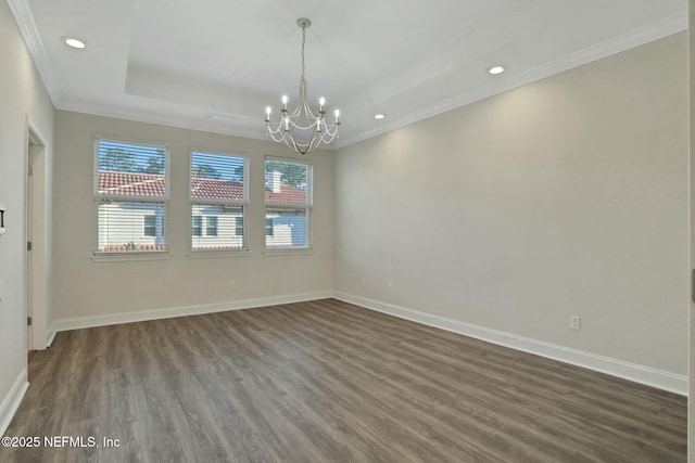 unfurnished room with baseboards, a tray ceiling, an inviting chandelier, and dark wood-style flooring