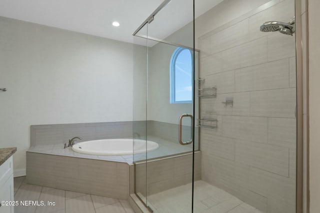 bathroom featuring vanity, a garden tub, a stall shower, and tile patterned floors