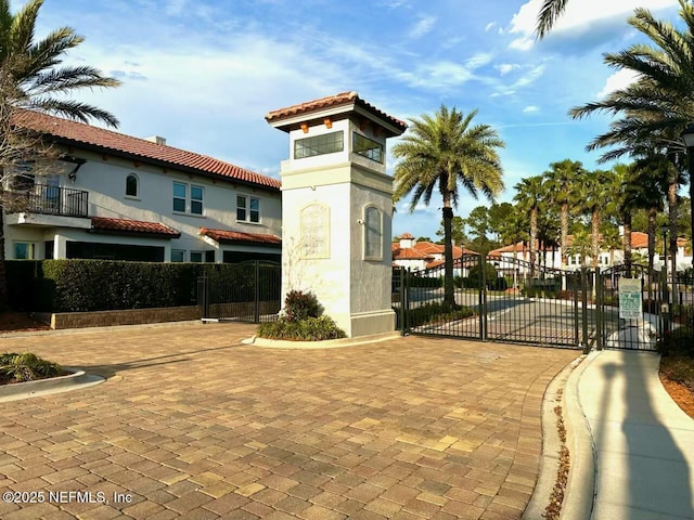 view of home's community featuring a gate and fence