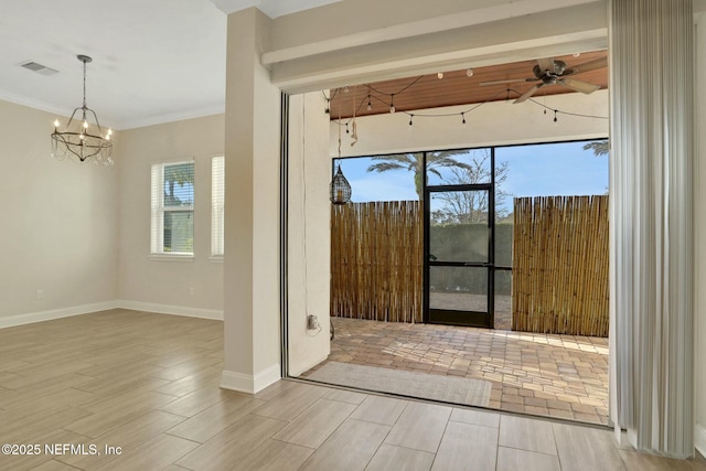 empty room with crown molding, ceiling fan with notable chandelier, visible vents, and wood tiled floor