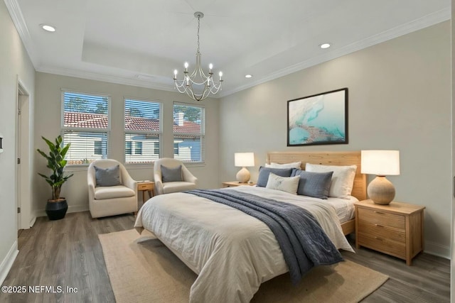 bedroom featuring wood finished floors, a chandelier, and crown molding