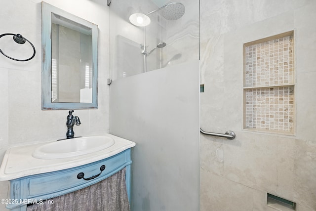 full bath featuring walk in shower and vanity