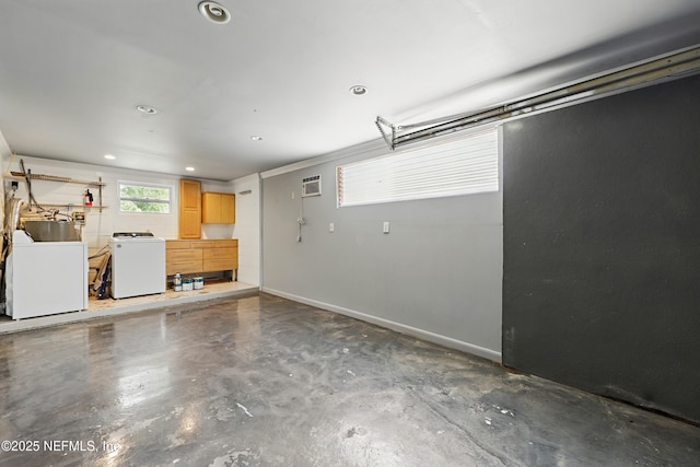 garage featuring recessed lighting, baseboards, and a wall mounted air conditioner