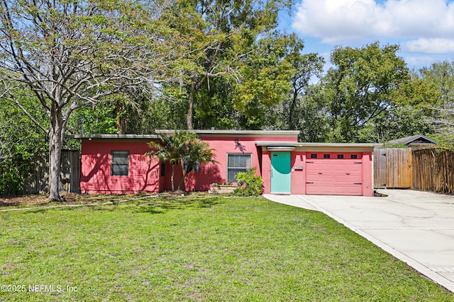 view of front of home with stucco siding, a front lawn, fence, concrete driveway, and an attached garage