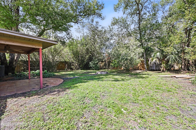 view of yard featuring a patio, central air condition unit, and fence