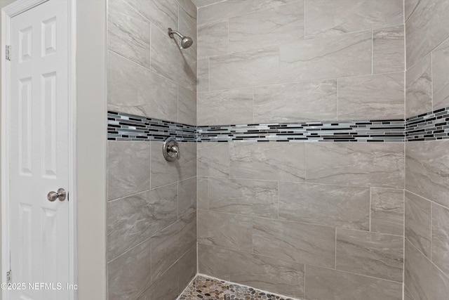 full bathroom with a tile shower