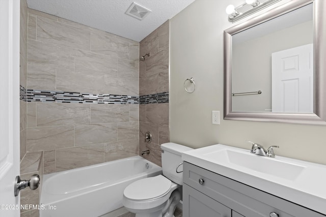 full bathroom featuring visible vents, toilet, vanity, bathtub / shower combination, and a textured ceiling