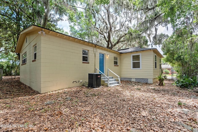 back of property featuring crawl space, central air condition unit, and fence