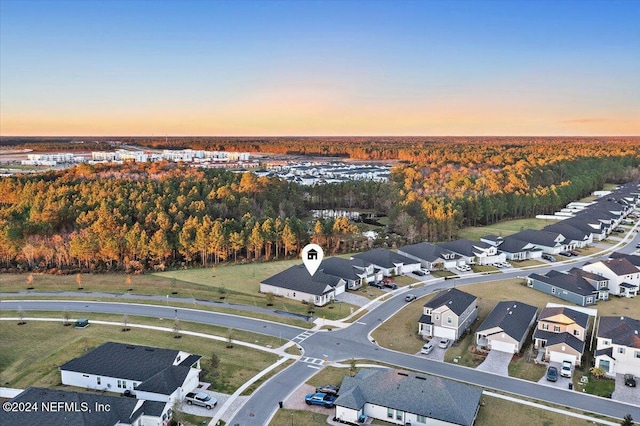 aerial view at dusk featuring a residential view