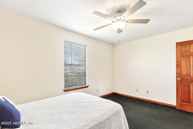 bedroom with dark colored carpet, baseboards, a textured ceiling, and ceiling fan