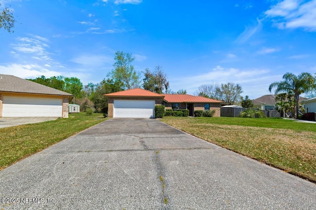 ranch-style house with a front yard and a detached garage