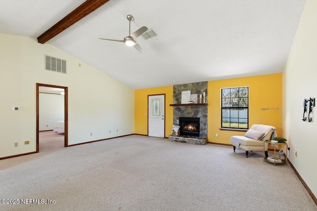 unfurnished living room featuring a stone fireplace, beamed ceiling, carpet, and visible vents