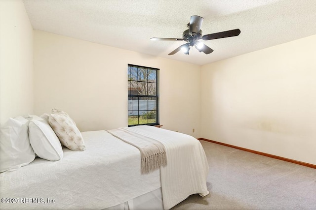 bedroom with carpet flooring, a textured ceiling, and baseboards