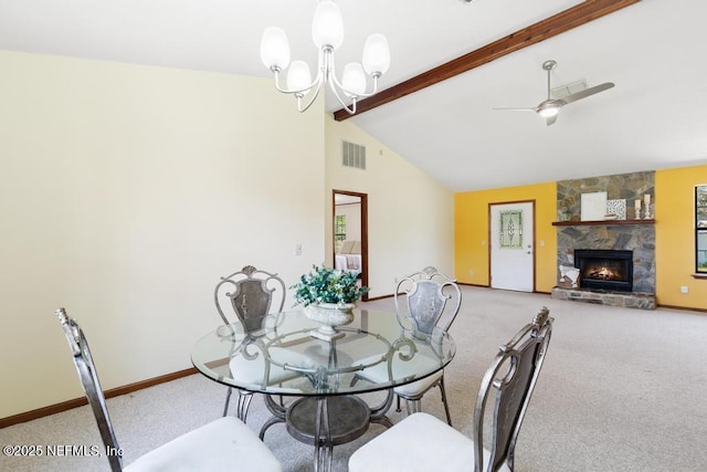 dining space with visible vents, beamed ceiling, a fireplace, and baseboards