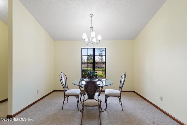 dining space with light carpet, a notable chandelier, a textured ceiling, and baseboards