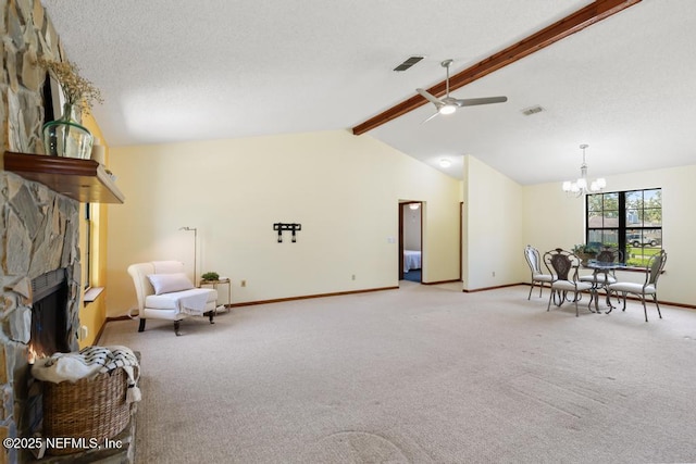 living area featuring a textured ceiling, a stone fireplace, carpet flooring, baseboards, and vaulted ceiling with beams