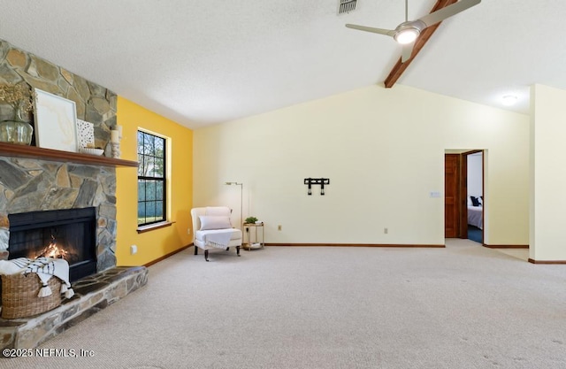 unfurnished room with carpet, lofted ceiling with beams, a fireplace, and visible vents