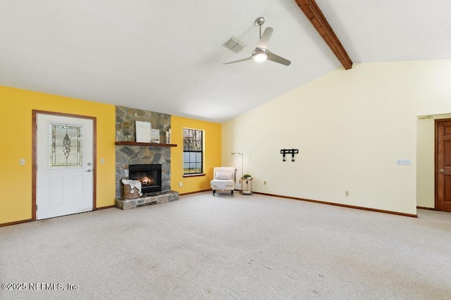 unfurnished room with visible vents, lofted ceiling with beams, a stone fireplace, carpet flooring, and ceiling fan