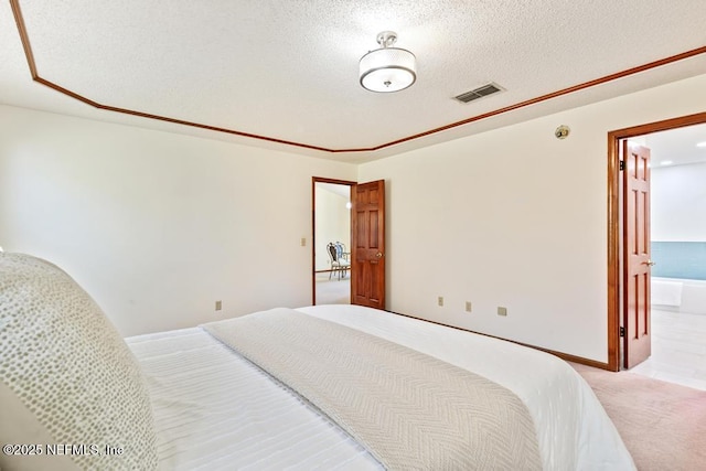 bedroom featuring carpet, visible vents, and a textured ceiling