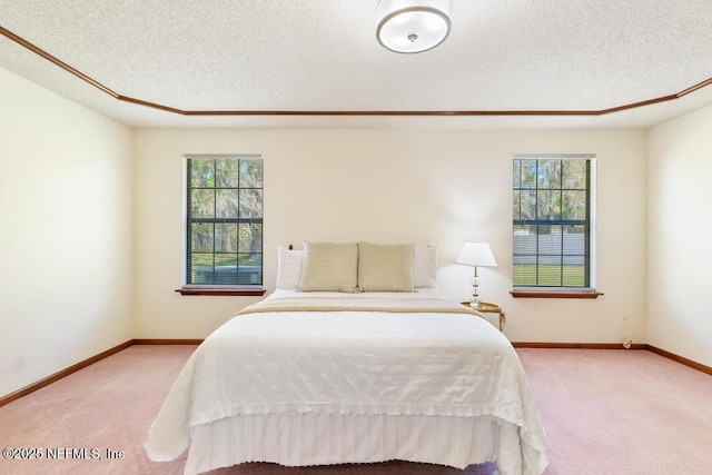 bedroom with baseboards, multiple windows, a textured ceiling, and carpet