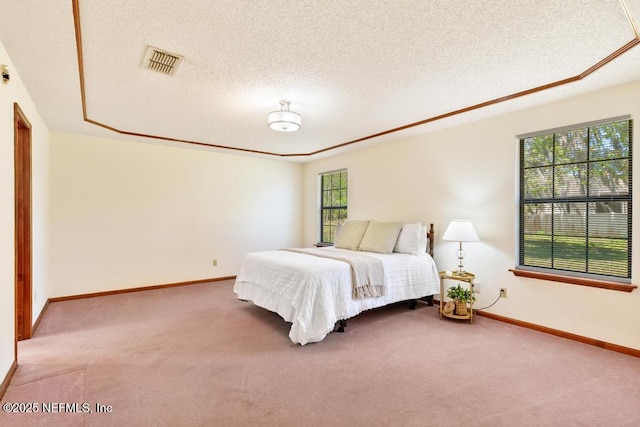 carpeted bedroom with visible vents, a textured ceiling, and baseboards