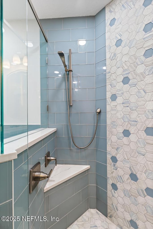 bathroom featuring a tile shower