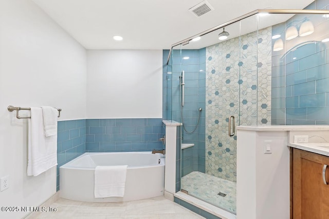 bathroom with vanity, visible vents, a stall shower, tile walls, and a bath