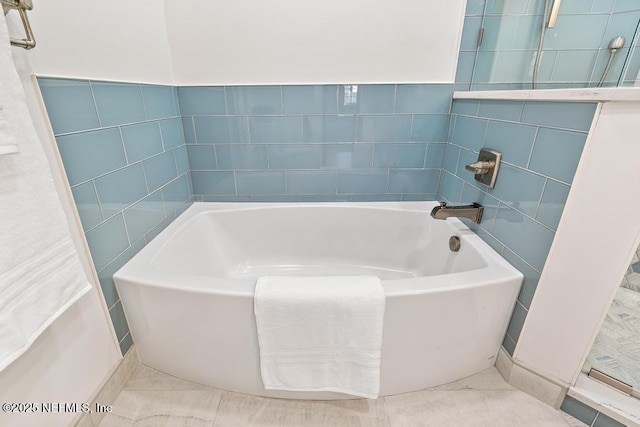 bathroom featuring tile walls, a bath, and tile patterned floors