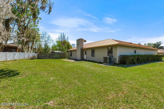 view of yard with central AC and a fenced backyard