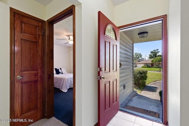 foyer entrance with light tile patterned floors