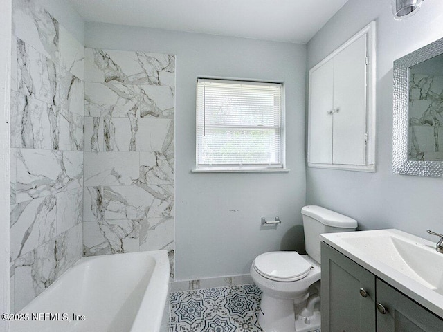 bathroom featuring baseboards, toilet, and vanity