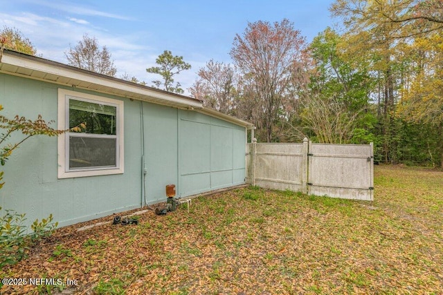 view of side of home featuring fence