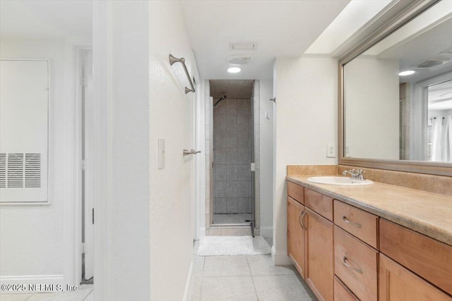 full bathroom with tile patterned flooring, a stall shower, vanity, and baseboards