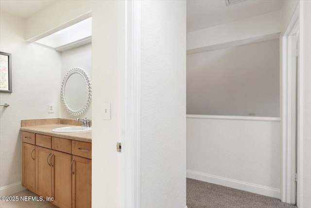 bathroom with vanity and baseboards