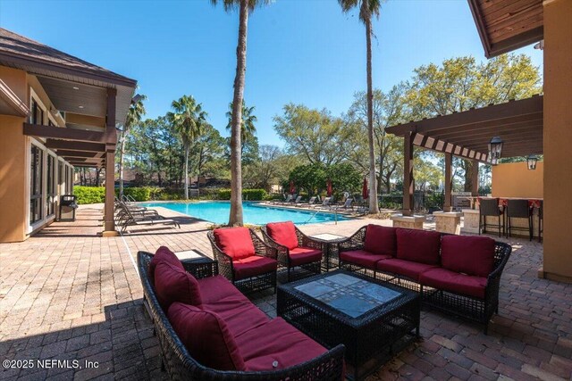 view of patio featuring a pergola, outdoor lounge area, and a community pool