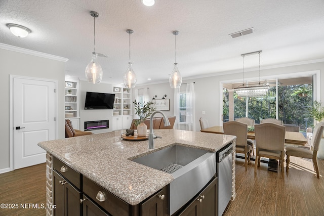 kitchen featuring visible vents, dishwasher, dark wood-type flooring, and ornamental molding