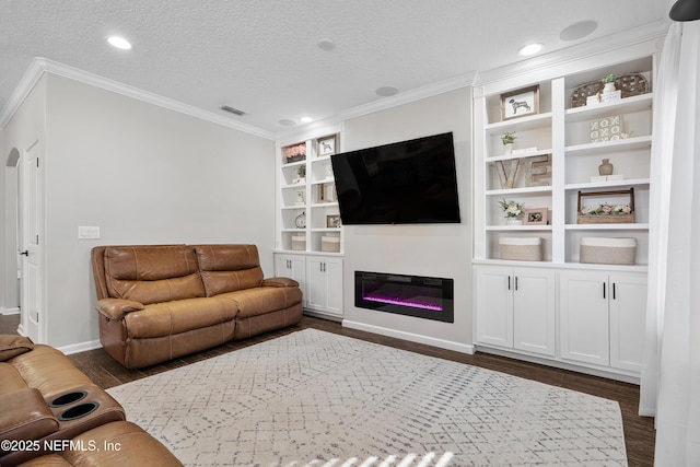 living area featuring dark wood finished floors, crown molding, a glass covered fireplace, and a textured ceiling