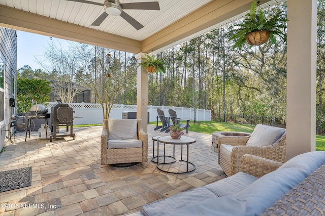 view of patio featuring a fenced backyard, a fire pit, area for grilling, and ceiling fan