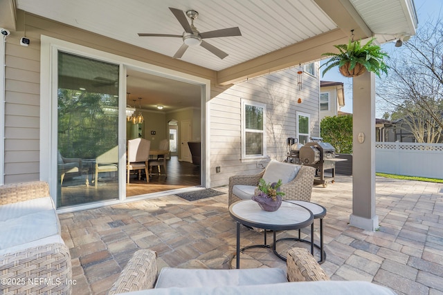 view of patio / terrace featuring a ceiling fan, fence, outdoor lounge area, and a grill