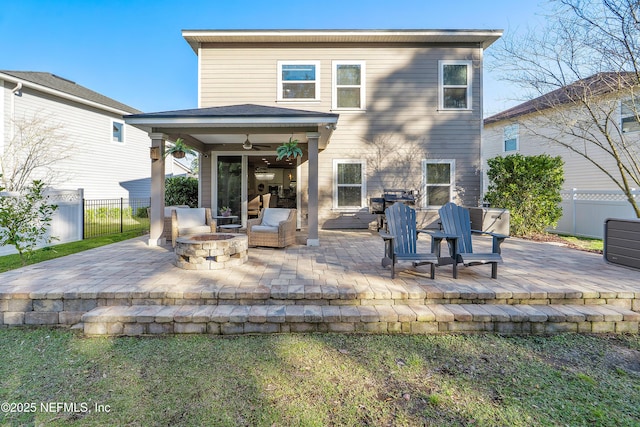 back of house featuring a patio, an outdoor fire pit, ceiling fan, and fence