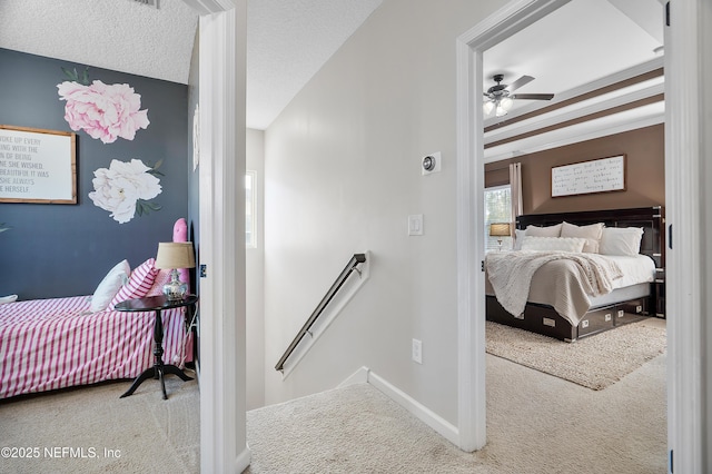 bedroom with baseboards, carpet floors, and a textured ceiling