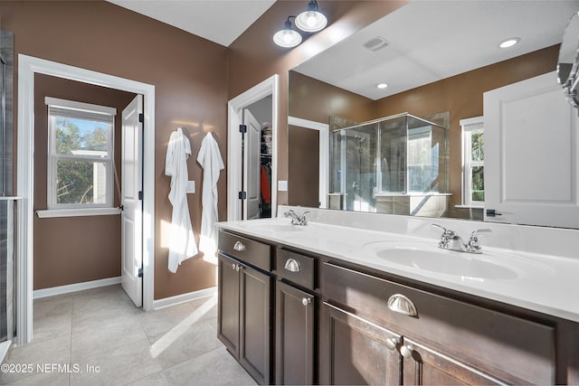 full bathroom with visible vents, plenty of natural light, and a sink