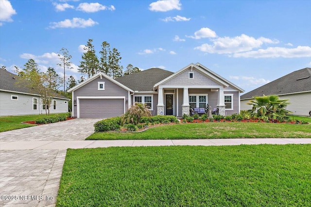 116 Clarendon Rd, Saint Johns, FL 32259 - view of front of house featuring a front lawn, decorative driveway, and a garage