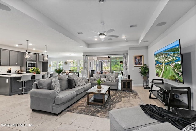 116 Clarendon Rd, Saint Johns, FL 32259 - living room featuring visible vents, ceiling fan, light tile patterned floors, and a raised ceiling